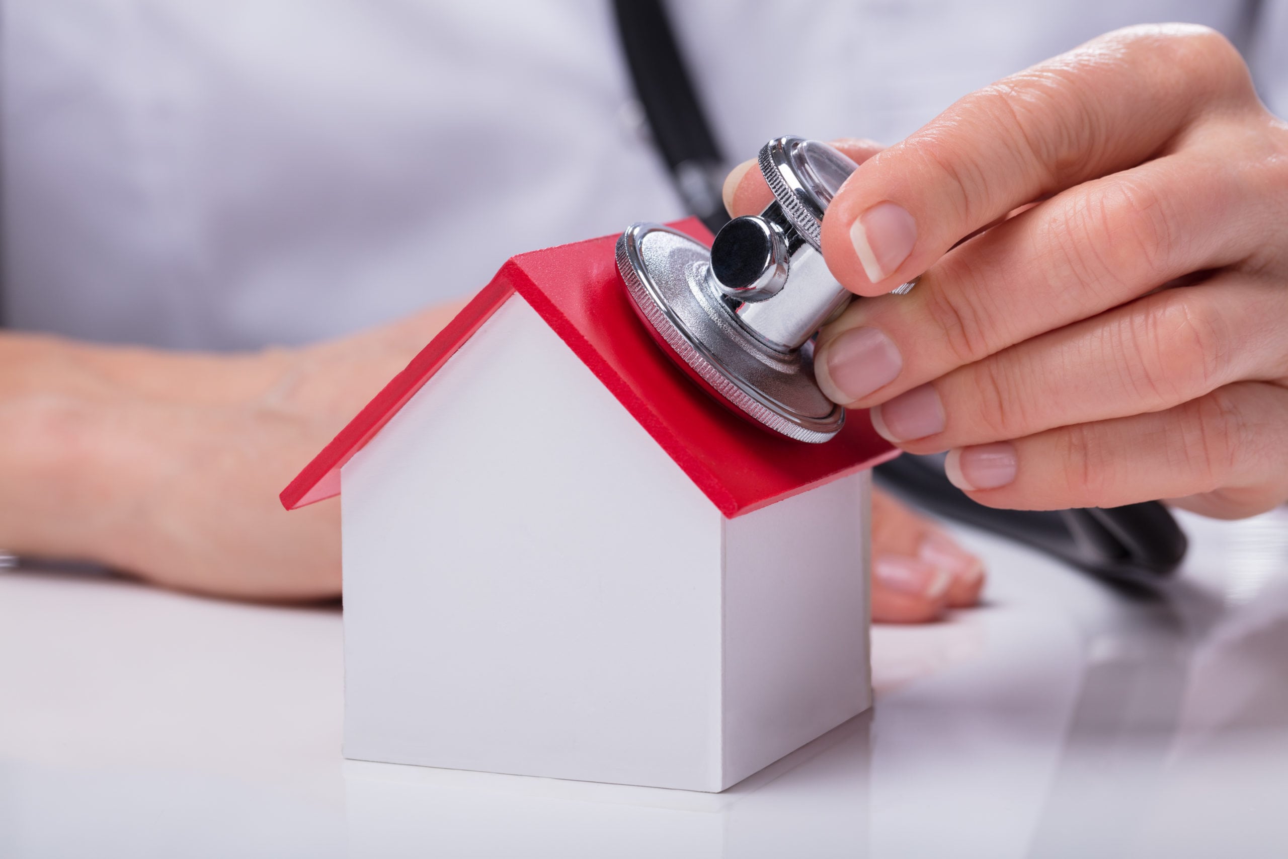 Stethoscope On Miniature Model Home